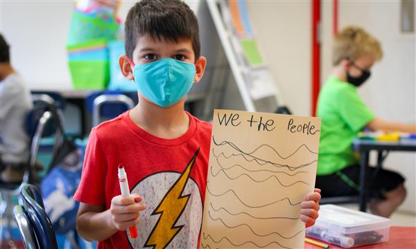 Boy holds up Constitution craft